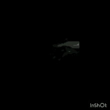 a black and white photo of a person lighting a match