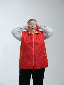 a woman wearing a red vest that says columbia on the front