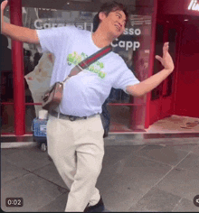 a man is dancing in front of a tim hortons restaurant