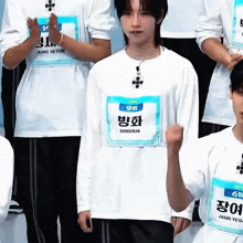 a boy wearing a white shirt with a name tag that says binghua