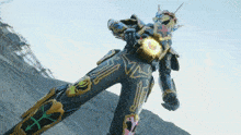 a person in a black and gold costume with the letter x on their pants