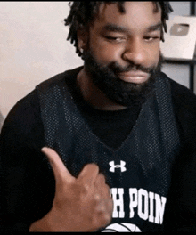 a man giving a thumbs up wearing a jersey that says point