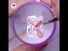 a woman 's nails are being painted in a purple circle