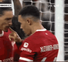 a soccer player wearing a red jersey with the number 7 on the back