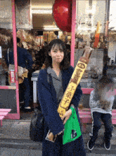 a woman in a blue coat is holding a yellow sign that says 250 on it