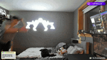 a room with a bed and a computer with a purple icon that says cptwillis on it