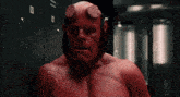 a man in a red costume is standing in front of lockers that have numbers on them .