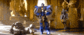 a robot is standing next to a statue of a man in a room .