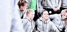 a group of female athletes wearing nike sweatshirts are posing for a picture