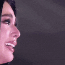 a close up of a woman 's face with tears running down her face .