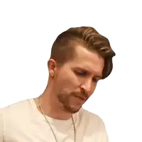 a man with a beard is wearing a white shirt and a necklace