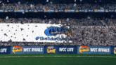 a soccer field with a banner that says wcc rivals on it