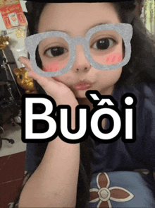 a girl wearing glasses with the word buoi written on it