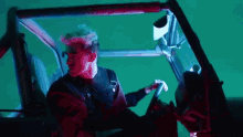 a man is sitting in the driver 's seat of a vehicle .