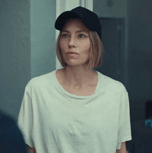 a woman wearing a black hat and a white t-shirt