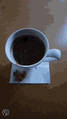 a cup of coffee on a napkin with a smiley face