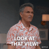 a man wearing glasses and a shirt that says look at that view