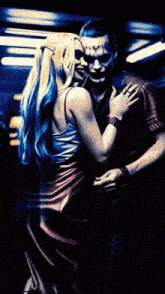 harley quinn and the joker are dancing in a dark room ..