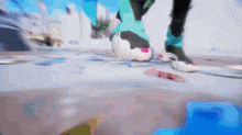 a blurry picture of a person 's feet and a skateboard on the ground