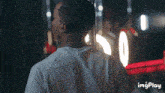 a man is standing in front of a mirror with a number 0 on it