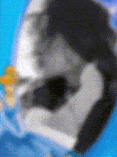 a blurred image of a person 's face with a blue background .
