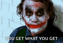 the joker is making a funny face and saying `` you get what you get ''