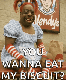 a wendy 's sign is behind a woman dressed as wendy 's wendy