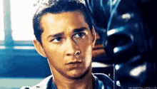 a close up of a man 's face with a serious expression .