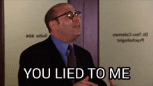 a bald man wearing glasses and a suit says you lied to me