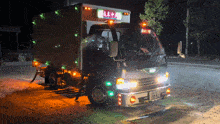 a truck with chinese writing on the side is parked at night