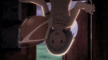 a girl is hanging upside down in a room