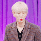 a man wearing a plaid jacket and a pearl necklace has the word always written on the bottom