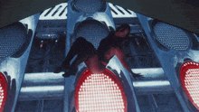a person is crawling on top of a row of red traffic lights