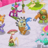 a bunch of cartoon monsters are standing on a table