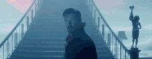 doctor strange is standing in front of a bridge in the fog .