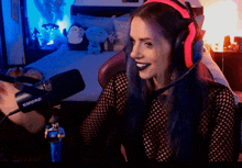 a woman wearing headphones and a shure microphone in front of a bed