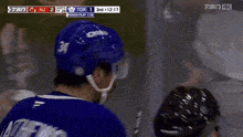 a hockey player in a blue jersey with the number 34 on it