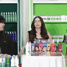 a woman is standing in front of a table full of hair dye