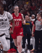 a female basketball player in a red fever 22 jersey