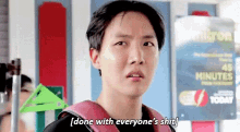 a young man with a backpack is standing in front of a sign that says done with everyone 's shit .