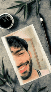 a picture of a man with a beard and a cup of coffee