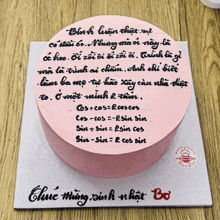 a pink cake with foreign writing on it