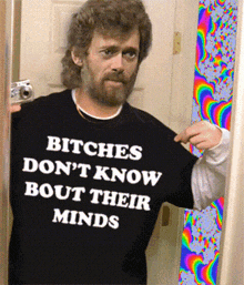 a man with a beard is wearing a shirt that says " bitches don 't know bout their minds "