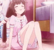 a girl in a pink dress is sitting on the floor while another girl brushing her hair