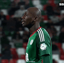a soccer player wearing a green jersey that says rsl on it
