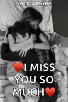 a man and a woman are hugging each other in a bed .