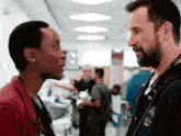 a man and a woman are standing next to each other in a hospital corridor .