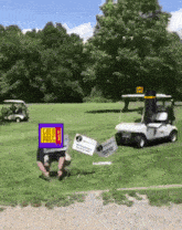 a golf cart is parked in a grassy field with a sign that says gold pass