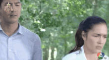 a man and a woman are standing next to each other with the number 7 on the screen