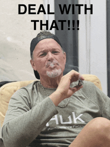 a man wearing a performance fishing shirt is smoking a cigar